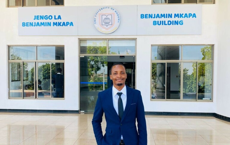 Edwin in front of his home university in Tanzania.